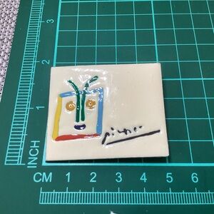 Picasso enameled metallic brooch